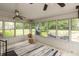 Bright sunroom with multiple windows offering views of the well-maintained backyard and outdoor furniture at 4195 Locust Ln, Brownsburg, IN 46112