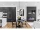 Modern dining area featuring a fireplace, TV, and kitchen with black cabinets at 420 Monon Wy Dr, Carmel, IN 46032