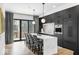 Modern kitchen with island, pendant lights, black cabinets, and stainless appliances at 420 Monon Wy Dr, Carmel, IN 46032