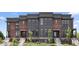 Stunning townhouse with brick and modern siding, steps and manicured landscaping at 420 Monon Wy Dr, Carmel, IN 46032