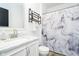 Clean bathroom featuring a marble vanity, modern faucet, and a shower with decorative curtain at 430 N Park Ave # 211, Indianapolis, IN 46202