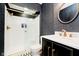 Chic bathroom with a luxe-patterned accent wall, marble countertop, and glass enclosed shower at 430 N Park Ave # 211, Indianapolis, IN 46202