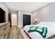 Stylish bedroom with modern decor, queen bed, and a dresser with large flat screen TV at 430 N Park Ave # 211, Indianapolis, IN 46202