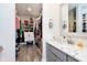 Large walk-in closet with custom shelving adjacent to a bathroom with marble countertops at 430 N Park Ave # 211, Indianapolis, IN 46202