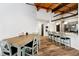 Open-concept dining area featuring a wood table set and a breakfast bar with pendant lighting at 430 N Park Ave # 211, Indianapolis, IN 46202