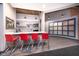 Modern kitchenette with stainless steel appliances, quartz countertop and red barstools at 430 N Park Ave # 211, Indianapolis, IN 46202