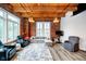 Bright living room with wood ceiling, exposed brick, and stylish furniture at 430 N Park Ave # 211, Indianapolis, IN 46202