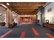 Spacious lobby with exposed brick, wood beams, modern carpet, and comfortable seating at 430 N Park Ave # 211, Indianapolis, IN 46202