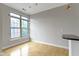 Bright dining area with hardwood floors and view to exterior through a large window at 450 E Ohio St # Apt 305, Indianapolis, IN 46204