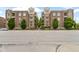 Charming brick condo building with balconies, mature trees, and manicured landscaping at 450 E Ohio St # Apt 305, Indianapolis, IN 46204