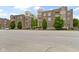 Attractive brick condo building with lush landscaping, a well-maintained lawn, and a tree-lined street at 450 E Ohio St # Apt 305, Indianapolis, IN 46204