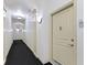 Bright condo hallway with decorative lighting leading to unit 305 at 450 E Ohio St # Apt 305, Indianapolis, IN 46204