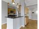 Open kitchen area with stainless appliances, light wood cabinetry, hardwood floors, and a raised breakfast bar at 450 E Ohio St # Apt 305, Indianapolis, IN 46204