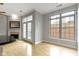 Bright living room features hardwood floors, fireplace, and view to exterior through french doors and large windows at 450 E Ohio St # Apt 305, Indianapolis, IN 46204