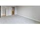 Spacious living room with neutral gray walls and plush carpeting at 450 E Ohio St # Apt 305, Indianapolis, IN 46204