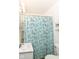 Bright bathroom with a turquoise shower curtain with ocean-themed design and white fixtures at 4751 Payton Ave, Lawrence, IN 46226