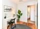 Bright bedroom featuring a stylish desk and hardwood floors adjacent to a bathroom with tile at 4751 Payton Ave, Lawrence, IN 46226