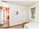 Bright and airy bedroom featuring hardwood floors and a large window to the outdoors at 4751 Payton Ave, Lawrence, IN 46226