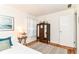 Charming bedroom with a classic armoire, soft light, and wood floors at 4751 Payton Ave, Lawrence, IN 46226