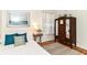 Charming bedroom with a classic armoire, soft light, neutral accents, and wood floors at 4751 Payton Ave, Lawrence, IN 46226