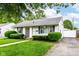 Well-kept home featuring a driveway and a lush green lawn at 4751 Payton Ave, Lawrence, IN 46226
