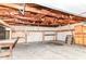 A spacious garage featuring wooden framework, a concrete floor and wooden cabinets at 4751 Payton Ave, Lawrence, IN 46226