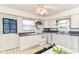 Functional kitchen with white cabinets, appliances, and a cozy breakfast nook at 4751 Payton Ave, Lawrence, IN 46226