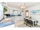 Efficient kitchen area with bright lighting, white cabinets and breakfast table at 4751 Payton Ave, Lawrence, IN 46226
