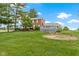 Spacious backyard featuring a large deck area, lawn and mature landscaping and beautiful home exterior at 4817 N 150 W, Anderson, IN 46011