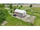 Aerial image of the barn, highlighting its construction, surrounding lot, and mature trees at 4817 N 150 W, Anderson, IN 46011