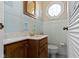 Bright bathroom features tiled walls, vanity with marble countertop, and octagon window at 4817 N 150 W, Anderson, IN 46011