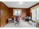 Bedroom featuring hardwood paneling, a neutral carpet, and multiple windows at 4817 N 150 W, Anderson, IN 46011