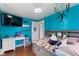 Bright bedroom with blue walls, a woven desk, a television and an animal themed bedspread and pillows at 4817 N 150 W, Anderson, IN 46011
