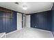Spare bedroom with carpeted floor, paneled walls, a couple of shelves and a closet at 4817 N 150 W, Anderson, IN 46011