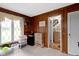 Bedroom features hardwood paneling, a neutral carpet, and a diamond paned window at 4817 N 150 W, Anderson, IN 46011