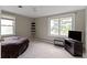 Bedroom featuring neutral walls, carpet, and a bed, complemented by a large window and a television on a dark stand at 4817 N 150 W, Anderson, IN 46011