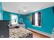 Vibrant bedroom features hardwood floors, colorful walls, and bright window at 4817 N 150 W, Anderson, IN 46011