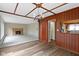 Open dining room features hardwood floors, wood paneled walls, and stylish chandelier lighting at 4817 N 150 W, Anderson, IN 46011
