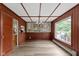 Dining room with paneled walls, hardwood floors, large window, and stylish chandelier lighting at 4817 N 150 W, Anderson, IN 46011