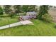 A lush lawn surrounds this traditional two-story home with red brick exterior, mature landscaping, and a charming front entry at 4817 N 150 W, Anderson, IN 46011