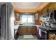 Well-lit kitchen with stainless steel appliances, wood cabinets, and a cozy window at 4817 N 150 W, Anderson, IN 46011