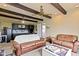 Inviting living room featuring beamed ceilings, neutral walls, and comfortable leather seating at 4817 N 150 W, Anderson, IN 46011