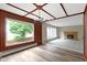 Spacious living room with hardwood floors, a brick fireplace, and large windows at 4817 N 150 W, Anderson, IN 46011