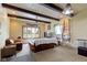 Cozy living room featuring wood paneling, exposed beams, and natural light from large windows at 4817 N 150 W, Anderson, IN 46011