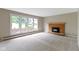 Bright living room boasts brick fireplace, neutral carpet, and large picture window at 4817 N 150 W, Anderson, IN 46011