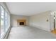 Spacious living room offers large window, brick fireplace, and neutral carpeting at 4817 N 150 W, Anderson, IN 46011