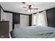 Main bedroom featuring dark walls, carpeted floors, two large windows, and a ceiling fan at 4817 N 150 W, Anderson, IN 46011