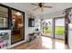 Bright sunroom with white brick walls, wood flooring, and views of the outdoors at 4817 N 150 W, Anderson, IN 46011