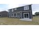 The backyard features a newly sodded lawn, patio, and large windows on the home at 4947 Amber Crest Dr, Brownsburg, IN 46112