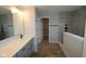 Modern bathroom with a double sink vanity, walk-in closet, and sleek tile shower, offering a luxurious feel at 4947 Amber Crest Dr, Brownsburg, IN 46112